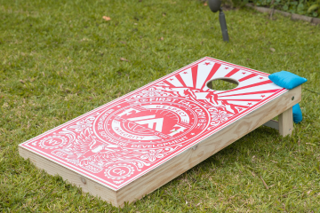 Cornhole game branded with First Factory's logo at the center so our employees can enjoy it outdoors