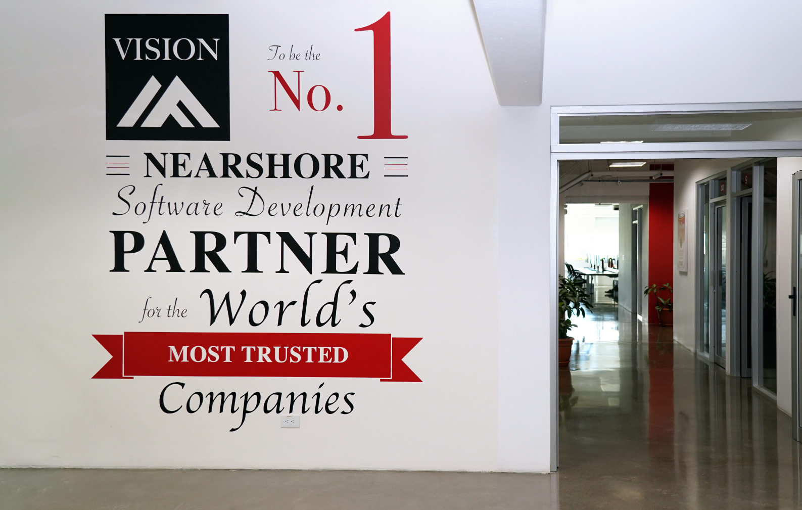 A mural on a wall at the office says ‘To be the No.1 nearshore Software Development partner for the world's most trusted companies'