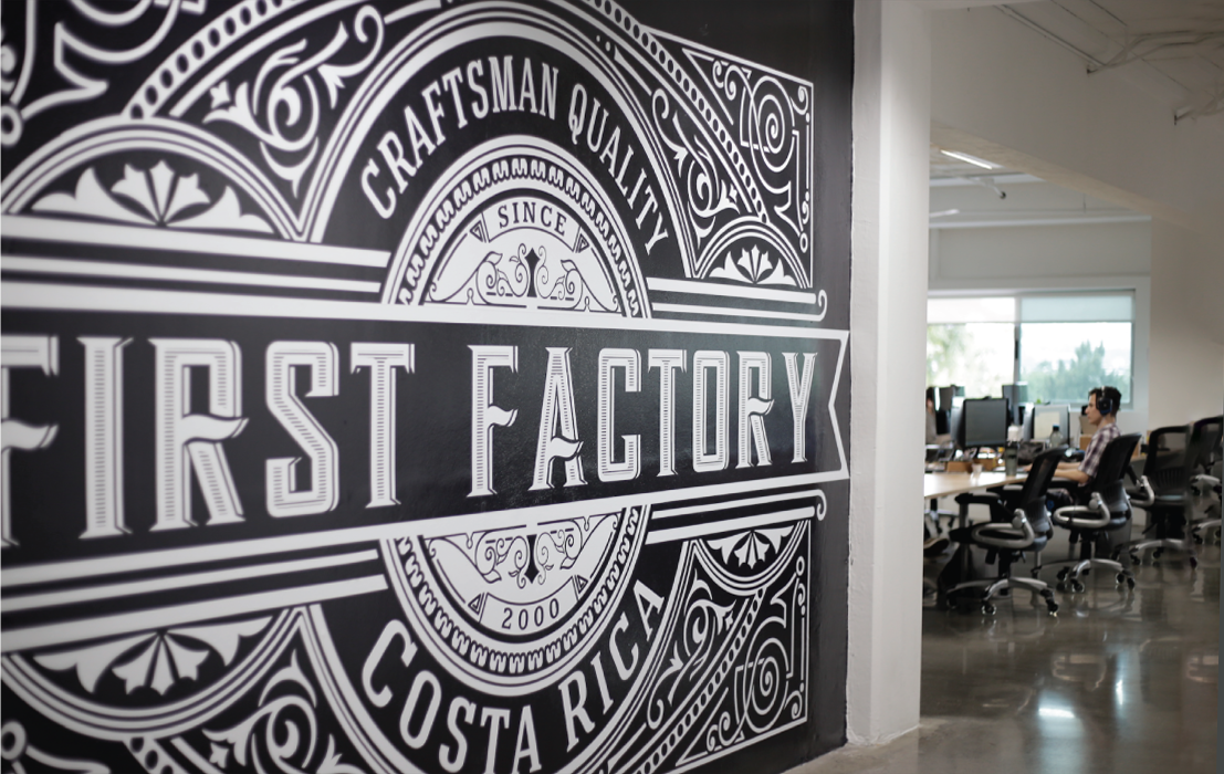 First Factory's black and white mural at the office says 'Craftsman quality, Costa Rica, since 2000